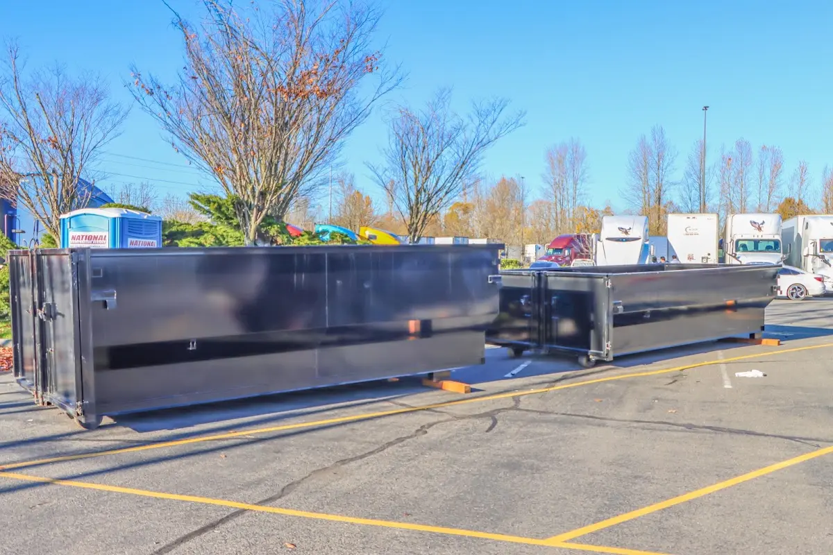 Professional dumpster rental service with roll-off container on residential driveway in Coffeyville